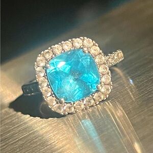 Sky blue topaz with diamond halo ring